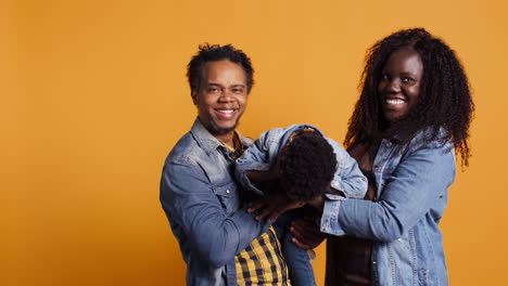 Portrait-of-african-american-family-with-a-little-child-posing-on-camera