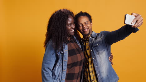 African-american-husband-and-wife-having-fun-taking-selfies-together-on-phone