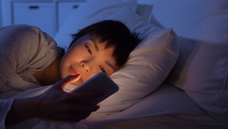 Sleeping-Woman-Awaking-Because-of-Phone-at-Night.technology,-internet,-communication-and-people-concept-young-african-american-woman-sleeping-in-bed-awaking-because-of-smartphone-at-home-at-night