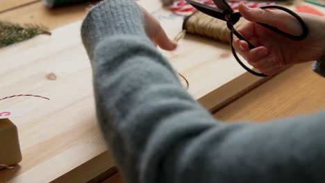 Hands-Making-Advent-Calender-on-Christmas-at-Home.winter-holidays-and-hobby-concept-hands-with-box-and-rope-making-advent-calender-or-packing-christmas-gift-at-home