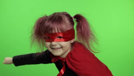 Funny-child-girl-in-costume-and-mask-plays-super-hero.-National-superhero-day