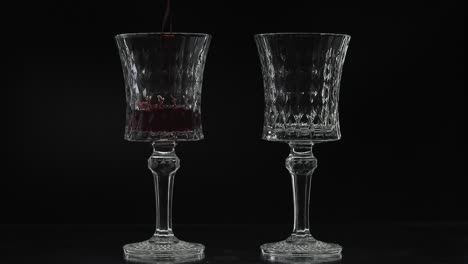 Rose-wine.-Red-wine-pour-in-two-wine-glasses-over-black-background.-Silhouette