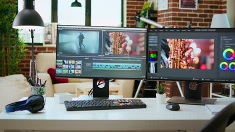 Empty-office-desk-with-a-video-editing-software-running-on-computer