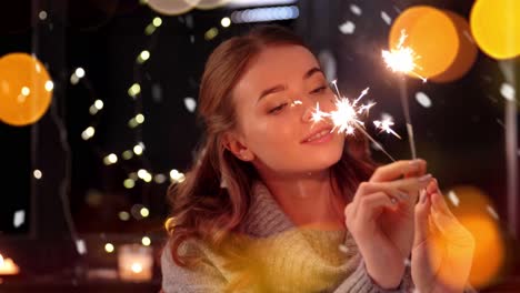 Happy-Young-Woman-Dancing-with-Sparklers.Happy-young-woman-dancing-with-sparklers-near-snowy-pine-trees