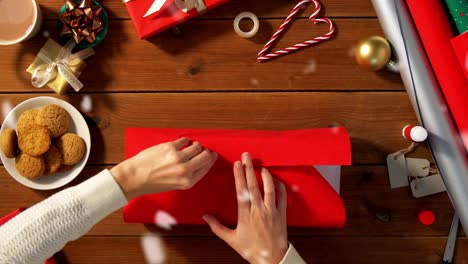 Woman-showing-Christmas-gift-wrapped-in-craft-paper-with-red-bow.-Vertical-video.Woman-showing-Christmas-gift-wrapped-in-craft-paper-with-red-bow.-Smiling-female-is-holding-New-Year-present-box.-Celebrating-Merry-Christmas-or-Happy-New-Year-2025.-Vertical-video