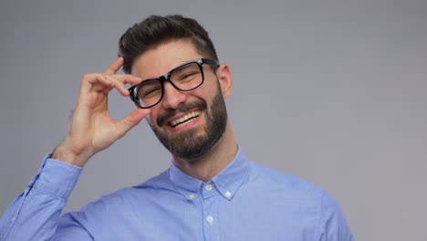 Happy-Portrait-of-Young-Man-Face-Looking-at-Camera-and-Smiling-in-Neon-Studio.Happy-Portrait-of-Young-Man-Looking-at-Camera-and-Smiling-in-Neon-Colored-Light.-Close-Up-View-on-Charming-White-Person-with-Cool-Grin.-Millennial-Model-Posing-Alone-in-Playful-Creative-Shoot-Inside