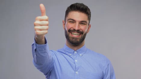 Happy-Portrait-of-a-Young-Caucasian-Man-Showing-Thumbs-Up-and-Looking-at-Camera-Smiling.Happy-portrait-of-a-young-caucasian-man-showing-thumbs-up-gesturing-approval-and-looking-at-camera-smiling,-standing-outdoors-in-the-city.-Vertical-footage.