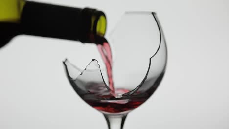 Wine.-Red-wine-pouring-in-broken-wine-glass-on-the-white-background