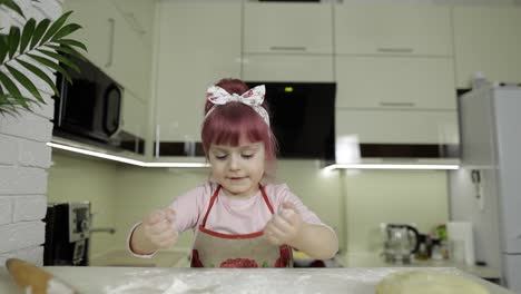 Cooking-pizza.-Little-child-playing-with-flour-gets-her-hands-dirty-in-kitchen