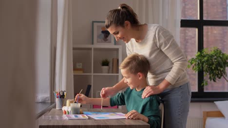 Asian-Mother-and-little-son-drawing-and-coloring-with-Crayons.Asian-Mother-and-little-son-drawing-and-coloring-with-Crayons.-Woman-and-little-child-boy-enjoy-painting-with-Crayons-on-paper-together.