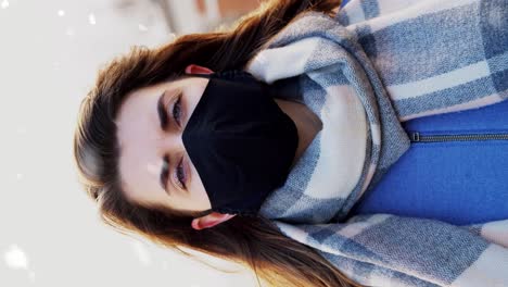 Woman-Wearing-Reusable-Protective-Mask-in-Winter.health,-safety-and-pandemic-concept-–-young-woman-wearing-black-face-protective-reusable-barrier-mask-outdoors-over-snow-in-winter