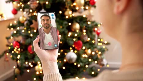 Woman-with-Smartphone-Has-Video-Call-on-Christmas.christmas,-technology-and-holidays-concept-–-close-up-of-young-woman-with-smartphone-having-video-with-senior-mother-call-at-home