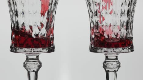 Rose-wine.-Red-wine-pour-in-two-wine-glasses-over-white-background