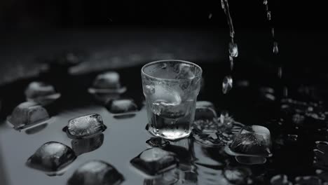 Pouring-up-shot-of-vodka-into-glass.-Black-background.-Pour-of-alcohol-drink