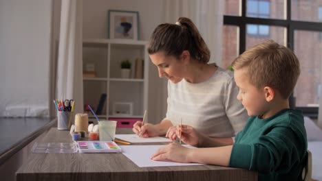 Asian-Mother-and-little-son-drawing-and-coloring-with-Crayons.Asian-Mother-and-little-son-drawing-and-coloring-with-Crayons.-Woman-and-little-child-boy-enjoy-painting-with-Crayons-on-paper-together.