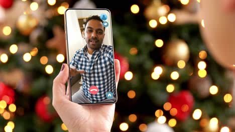 Woman-with-Smartphone-Has-Video-Call-on-Christmas.christmas,-technology-and-holidays-concept-–-close-up-of-young-woman-with-smartphone-having-video-with-senior-mother-call-at-home