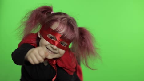 Funny-child-girl-in-costume-and-mask-plays-super-hero.-National-superhero-day