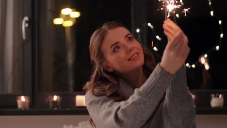 Happy-Young-Woman-Dancing-with-Sparklers.Happy-young-woman-dancing-with-sparklers-near-snowy-pine-trees