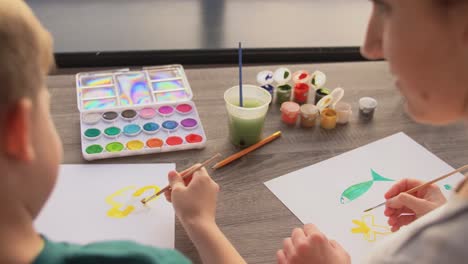 Asian-Mother-and-little-son-drawing-and-coloring-with-Crayons.Asian-Mother-and-little-son-drawing-and-coloring-with-Crayons.-Woman-and-little-child-boy-enjoy-painting-with-Crayons-on-paper-together.