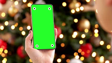 Woman-Holding-Smartphone-with-Green-Screen-for-Mockup.A-woman-holding-a-smartphone-with-a-green-screen-for-mockup-purposes,-with-a-focus-on-the-phone