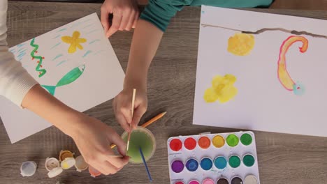 Asian-Mother-and-little-son-drawing-and-coloring-with-Crayons.Asian-Mother-and-little-son-drawing-and-coloring-with-Crayons.-Woman-and-little-child-boy-enjoy-painting-with-Crayons-on-paper-together.