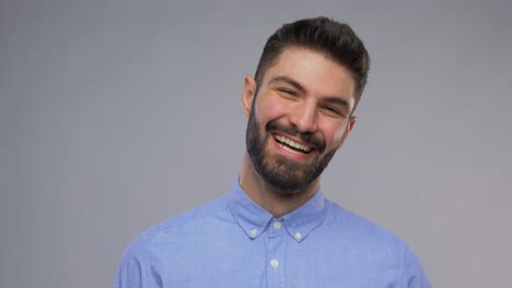 Happy-Portrait-of-Young-Man-Face-Looking-at-Camera-and-Smiling-in-Neon-Studio.Happy-Portrait-of-Young-Man-Looking-at-Camera-and-Smiling-in-Neon-Colored-Light.-Close-Up-View-on-Charming-White-Person-with-Cool-Grin.-Millennial-Model-Posing-Alone-in-Playful-Creative-Shoot-Inside