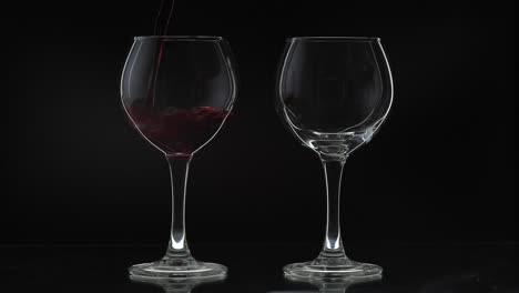 Rose-wine.-Red-wine-pour-in-two-wine-glasses-over-black-background.-Silhouette