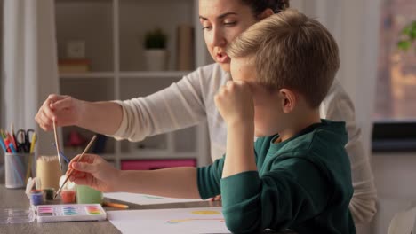 Asian-Mother-and-little-son-drawing-and-coloring-with-Crayons.Asian-Mother-and-little-son-drawing-and-coloring-with-Crayons.-Woman-and-little-child-boy-enjoy-painting-with-Crayons-on-paper-together.