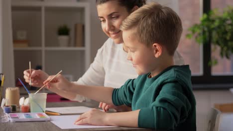 Asian-Mother-and-little-son-drawing-and-coloring-with-Crayons.Asian-Mother-and-little-son-drawing-and-coloring-with-Crayons.-Woman-and-little-child-boy-enjoy-painting-with-Crayons-on-paper-together.