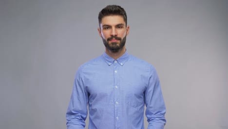 Happy-Young-Man-with-Bunch-of-Flowers-and-Gift-Box.valentines-day,-greeting-and-holidays-concept-–-video-portrait-of-happy-smiling-young-man-with-bunch-of-flowers-and-gift-box-in-shape-of-heart-over-grey-background