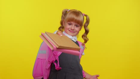 Cheerful-schoolgirl-kid-dressed-in-uniform-showing-books-on-camera,-encourages-to-study-together