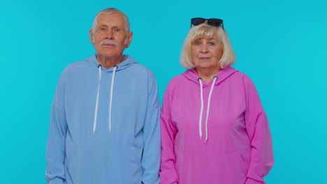 Elderly-granny-with-grandfather-pointing-to-camera-looking-with-happy-expression,-making-choice