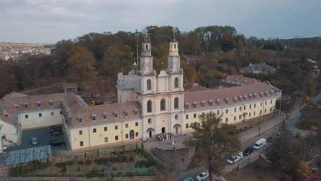 Aerial-view-of-catholic-cathedral-monastery-in-autumn.-City-Buchach,-Ukraine