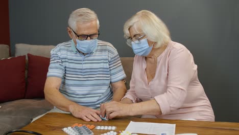 Senior-couple-grandfather-and-grandmother-monitoring-oxygen-saturation-with-digital-pulse-oximeter