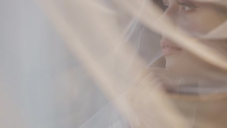 Portrait-of-bride-face-close-up-under-veil,-girl-touching-her-lips,-wedding-morning-preparations