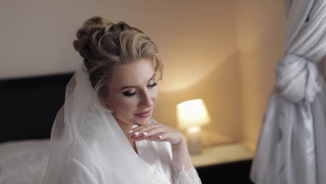 Beautiful-and-lovely-bride-in-night-gown-and-veil.-Wedding-morning.-Slow-motion