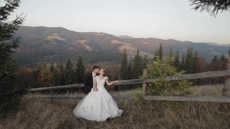 Newlyweds.-Caucasian-groom-with-bride-on-mountain-slope.-Wedding-couple.-Happy