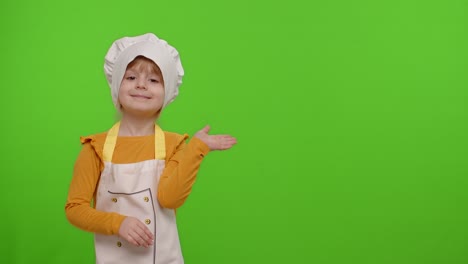 Child-girl-dressed-like-chef-cook-pointing-at-right-on-blank-space-place-for-your-advertisement-logo