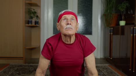 Senior-grandfather-man-pensioner-doing-workout,-training,-fitness,-sport-push-up-exercises-at-home