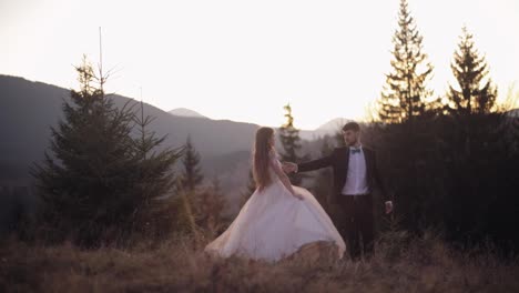 Newlyweds.-Caucasian-groom-with-bride-dancing-on-mountain-slope.-Wedding-couple