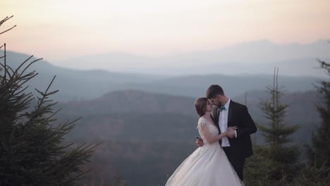 Newlyweds.-Caucasian-groom-with-bride-on-mountain-slope.-Wedding-couple.-Happy