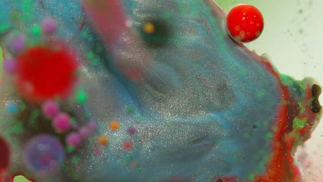 Top-view-movement-of-dark-oil-ink-drops-bubbles,-multicolored-artistic-paint-surface-background