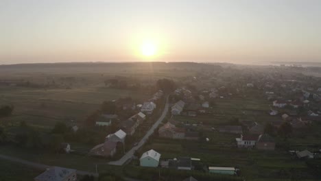 Aerial-drone-view-over-old-village-at-sunrise.-Thick-fog-covered-all-the-fields