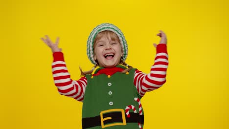 Kid-girl-child-in-Christmas-elf-Santa-helper-costume-showing-thumbs-up-gesture.-New-Year-holiday