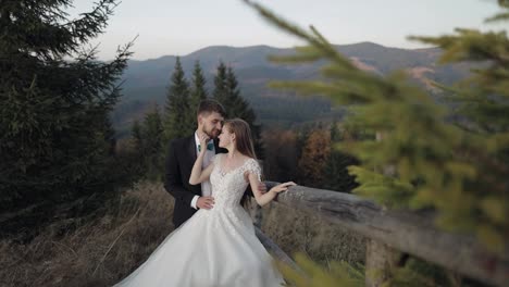 Newlyweds.-Caucasian-groom-with-bride-on-mountain-slope.-Wedding-couple.-Happy