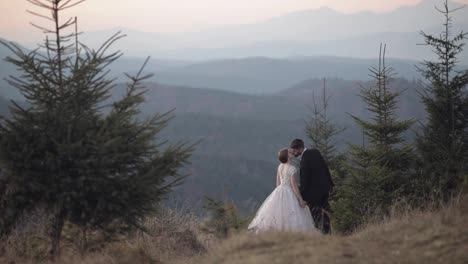 Newlyweds.-Caucasian-groom-with-bride-on-mountain-slope.-Wedding-couple.-Happy