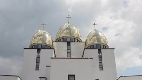 Dome-of-church,-aerial-view,-traditional-old-church-in-city-Lviv,-Ukraine,-cloudy-sky-background