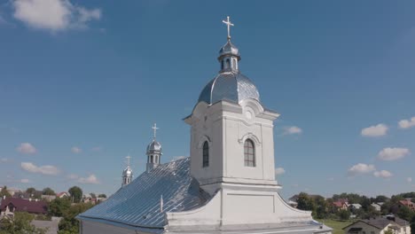 Dome-of-church,-Aerial-view,-Traditional-old-church-in-Ukraine-small-village,-Blue-sky-background