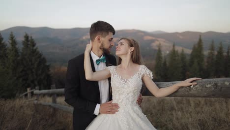 Newlyweds.-Caucasian-groom-with-bride-on-mountain-slope.-Wedding-couple.-Happy