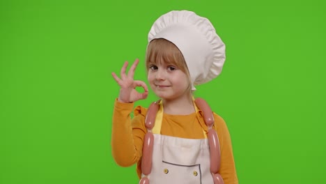 Child-girl-dressed-in-apron-like-chef-cook-showing-approval-ok-sign,-tasty-gesture,-chroma-key